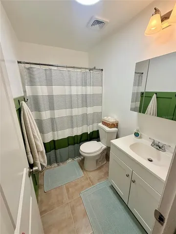 a bathroom with a double vanity sink toilet and shower