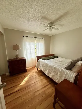 a bedroom with a bed and a mirror