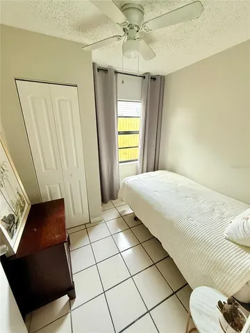 a bedroom with a bed and a mirror