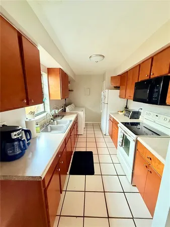a kitchen with stainless steel appliances a stove a sink and a microwave