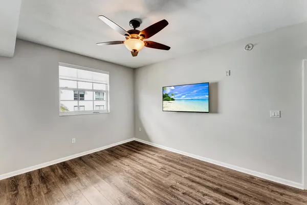 a view of empty room with wooden floor