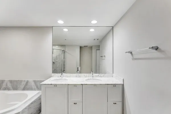 a bathroom with a double vanity sink and mirror