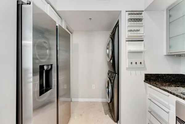a kitchen with a refrigerator and a stove top oven