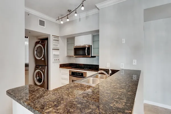 a kitchen with granite countertop a stove and a sink