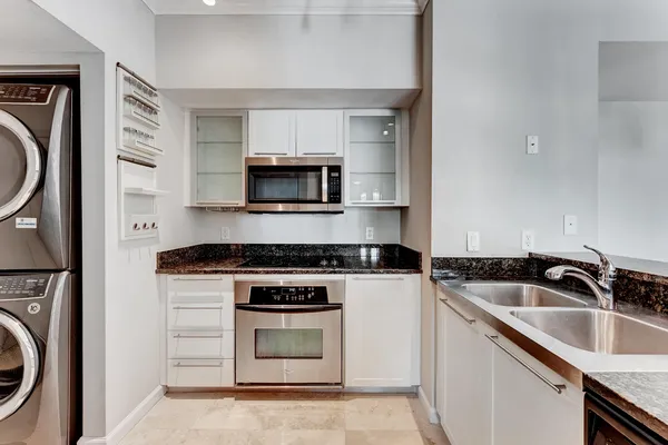 a kitchen with sink a stove and microwave