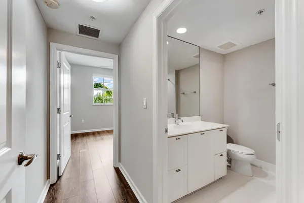 a bathroom with a toilet sink and mirror