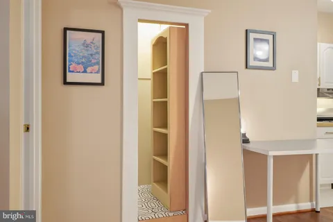 a view of a hallway with paintings on the wall