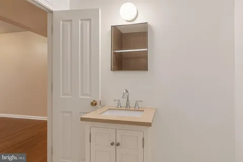 a bathroom with a sink a mirror and a vanity