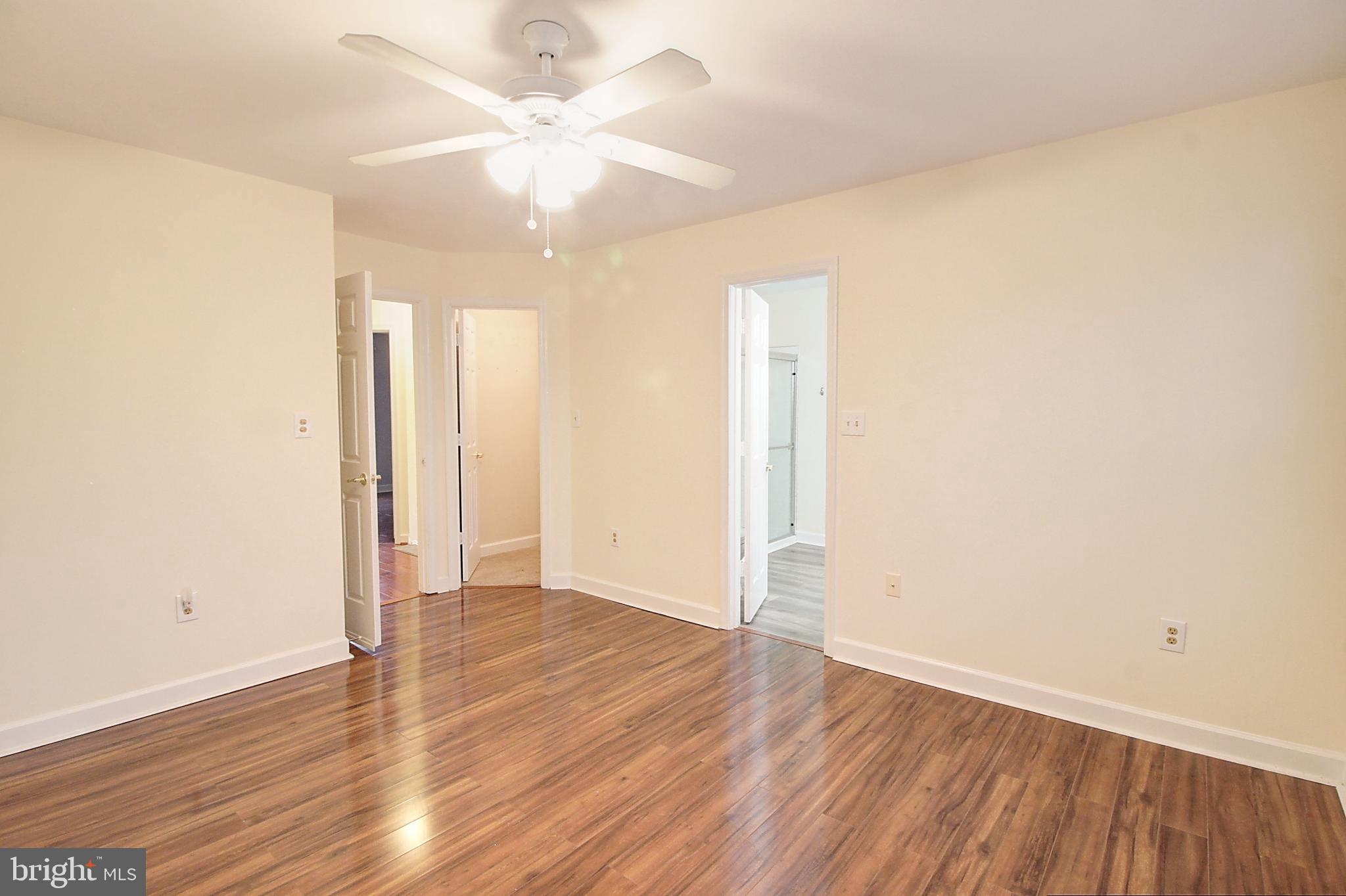 9261 Ridgefield Circle Frederick, MD 21701 - Photo 11 of 27 an empty room with wooden floor and a ceiling fan