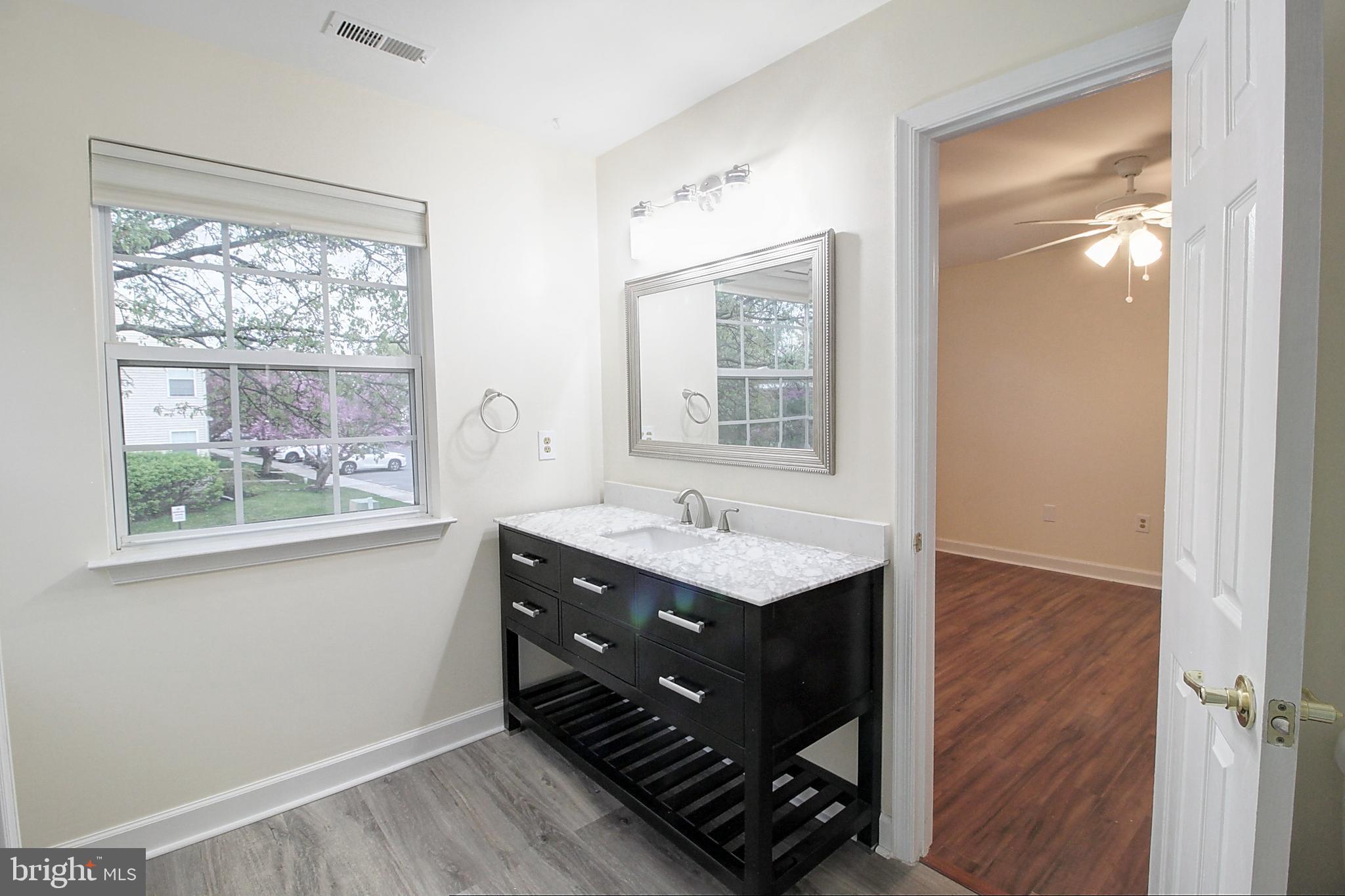 9261 Ridgefield Circle Frederick, MD 21701 - Photo 15 of 27 a bathroom with a sink a mirror and next to a window