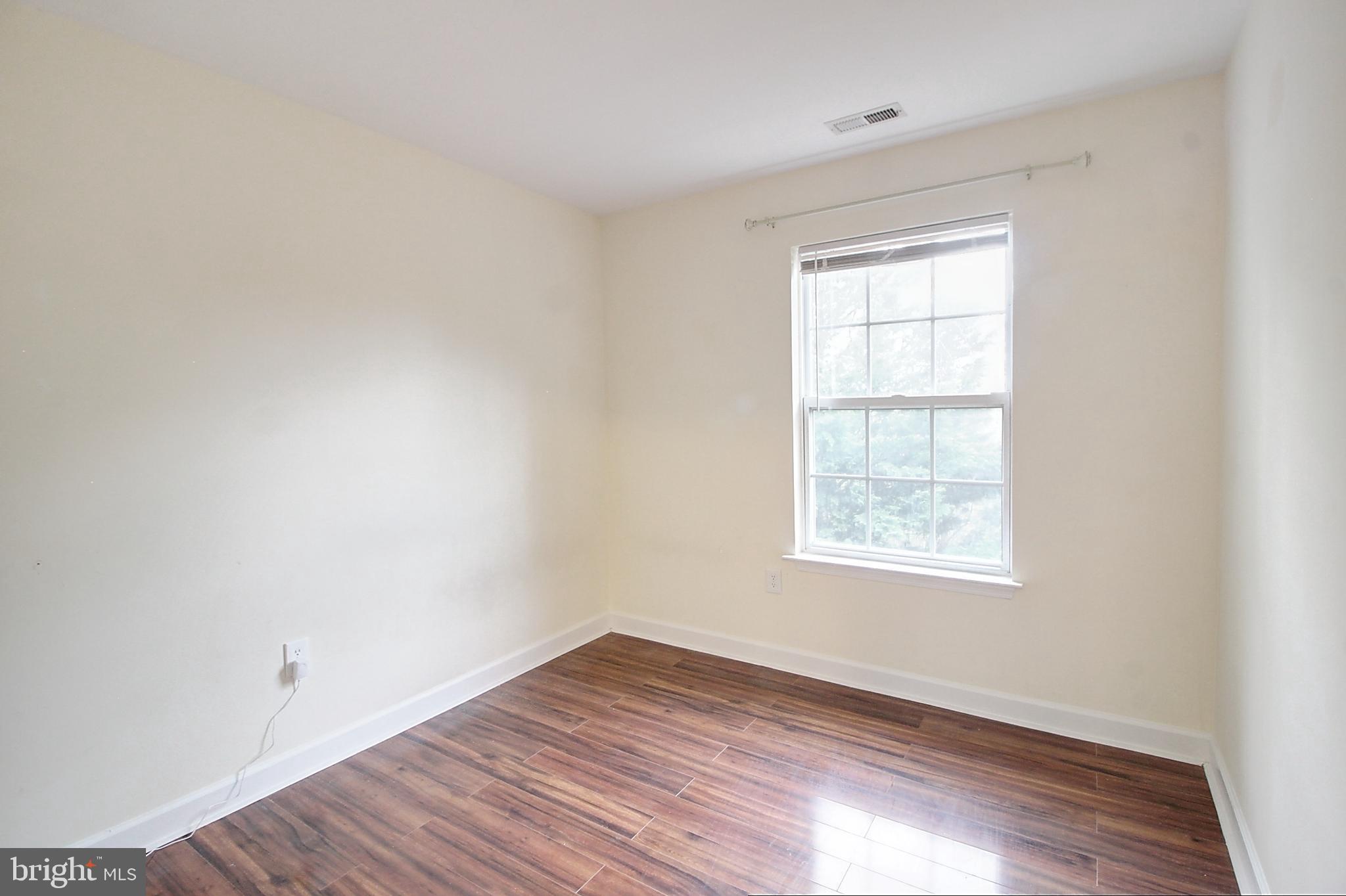 9261 Ridgefield Circle Frederick, MD 21701 - Photo 19 of 27 an empty room with wooden floor and windows