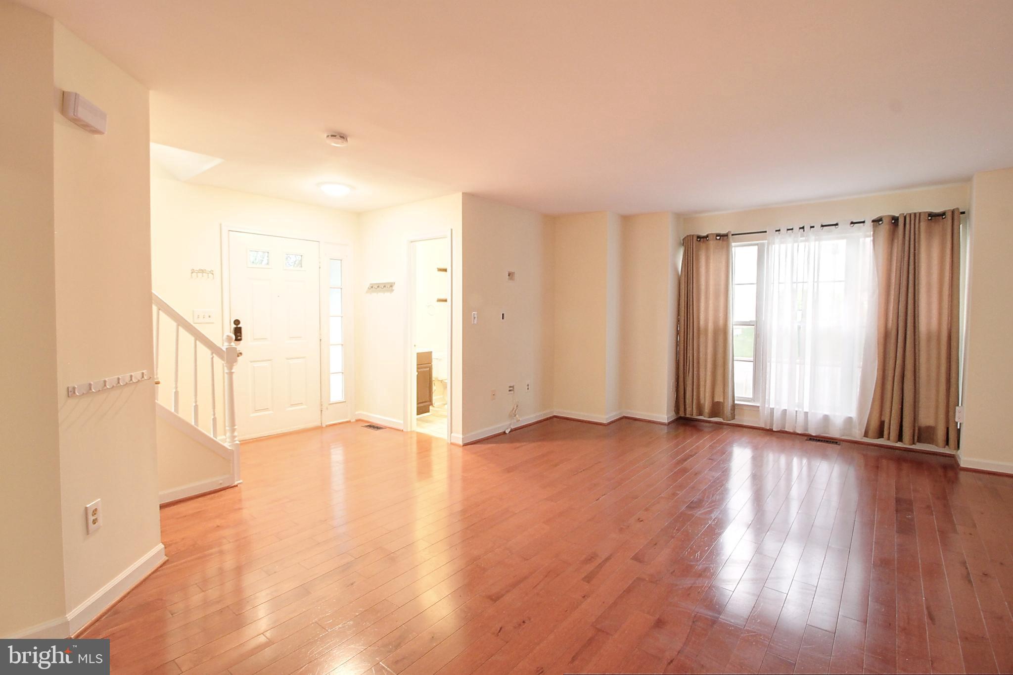 9261 Ridgefield Circle Frederick, MD 21701 - Photo 3 of 27 a view of an empty room with wooden floor and a window