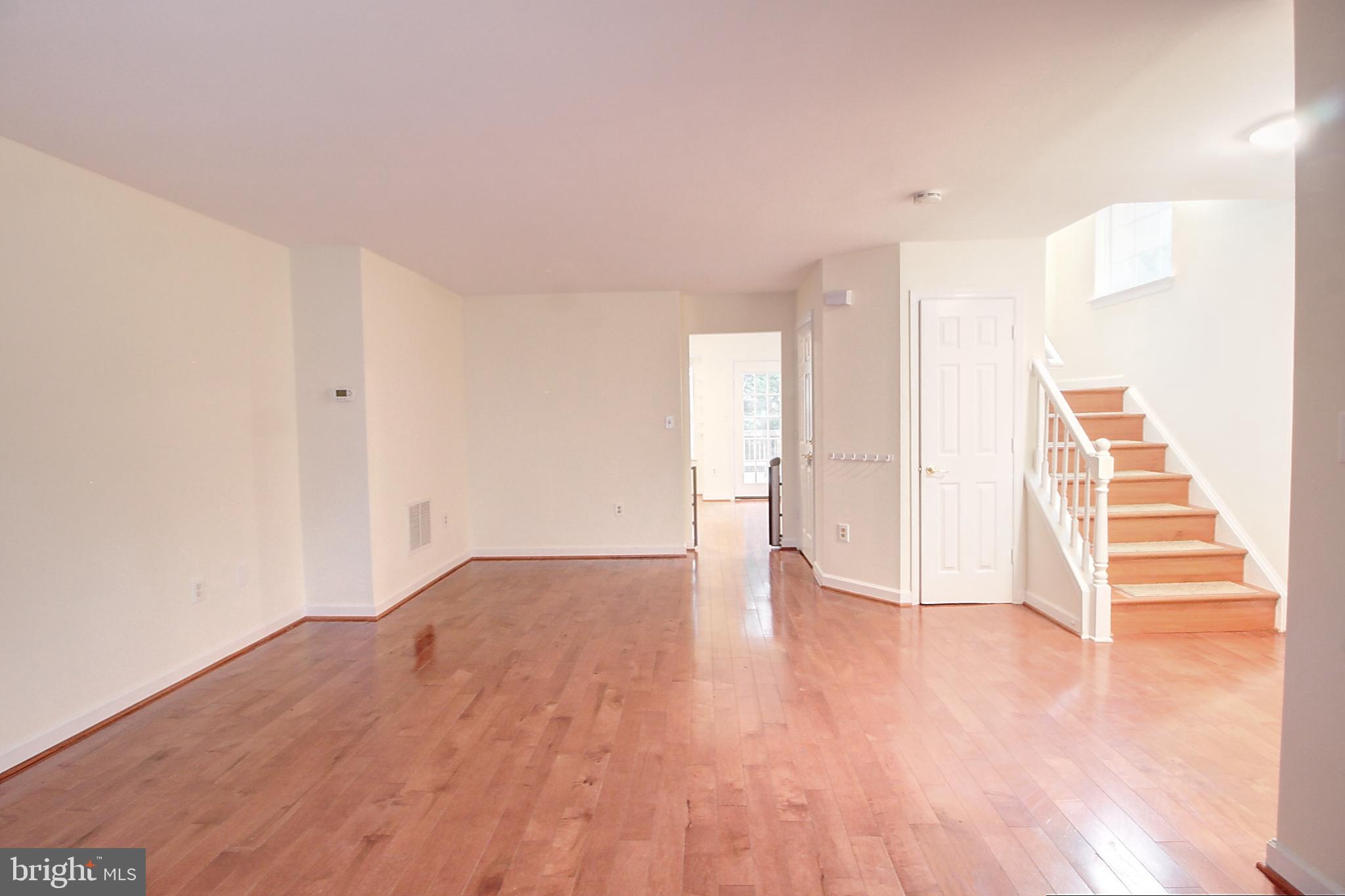 9261 Ridgefield Circle Frederick, MD 21701 - Photo 5 of 27 a view of empty room with wooden floor and window