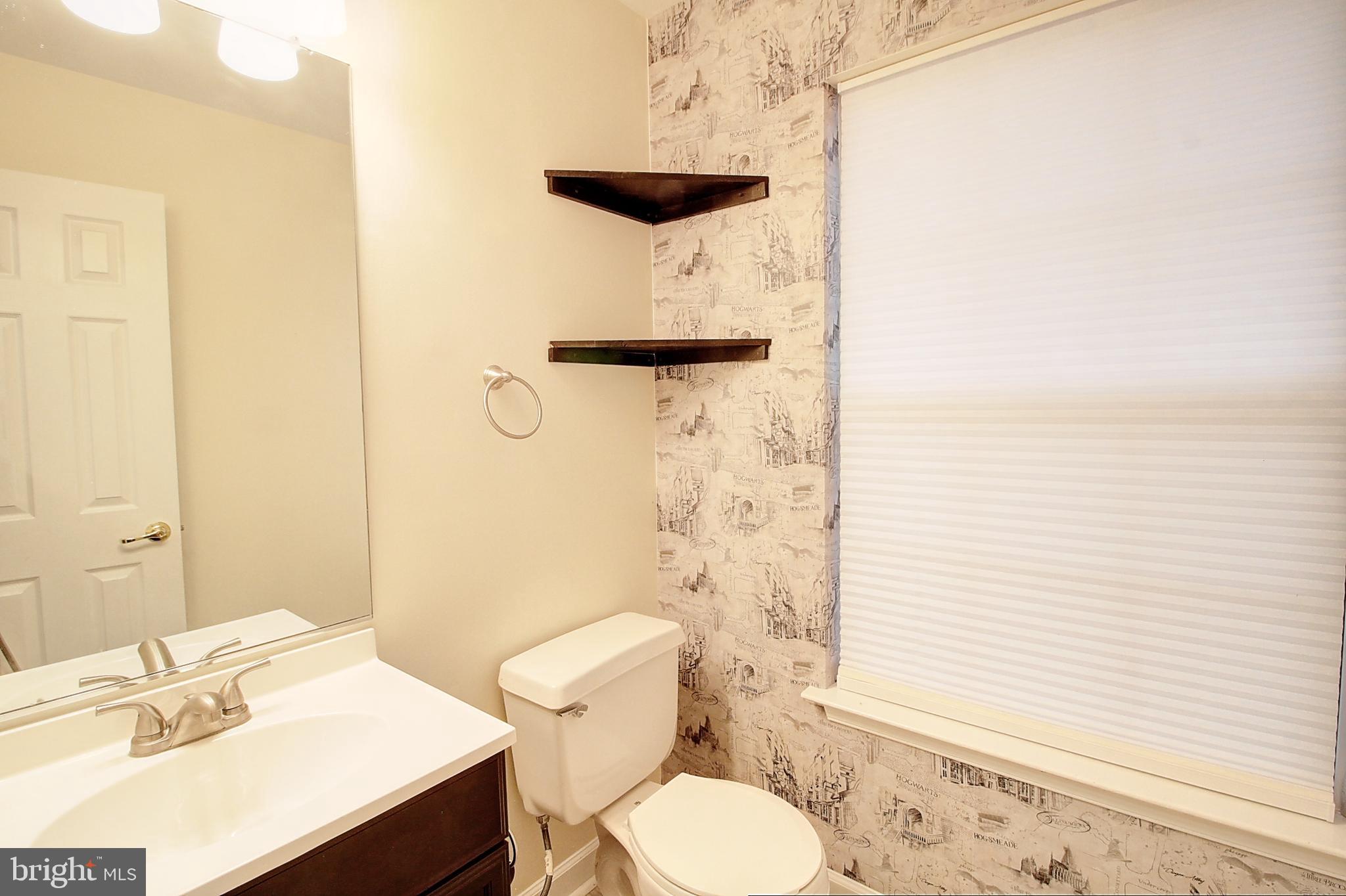 9261 Ridgefield Circle Frederick, MD 21701 - Photo 6 of 27 a bathroom with a sink a toilet and shower curtain