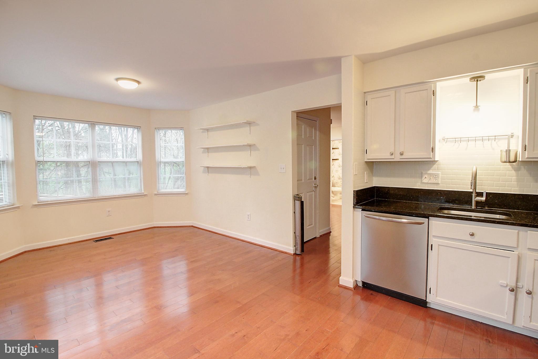 9261 Ridgefield Circle Frederick, MD 21701 - Photo 7 of 27 a kitchen with granite countertop white cabinets and window