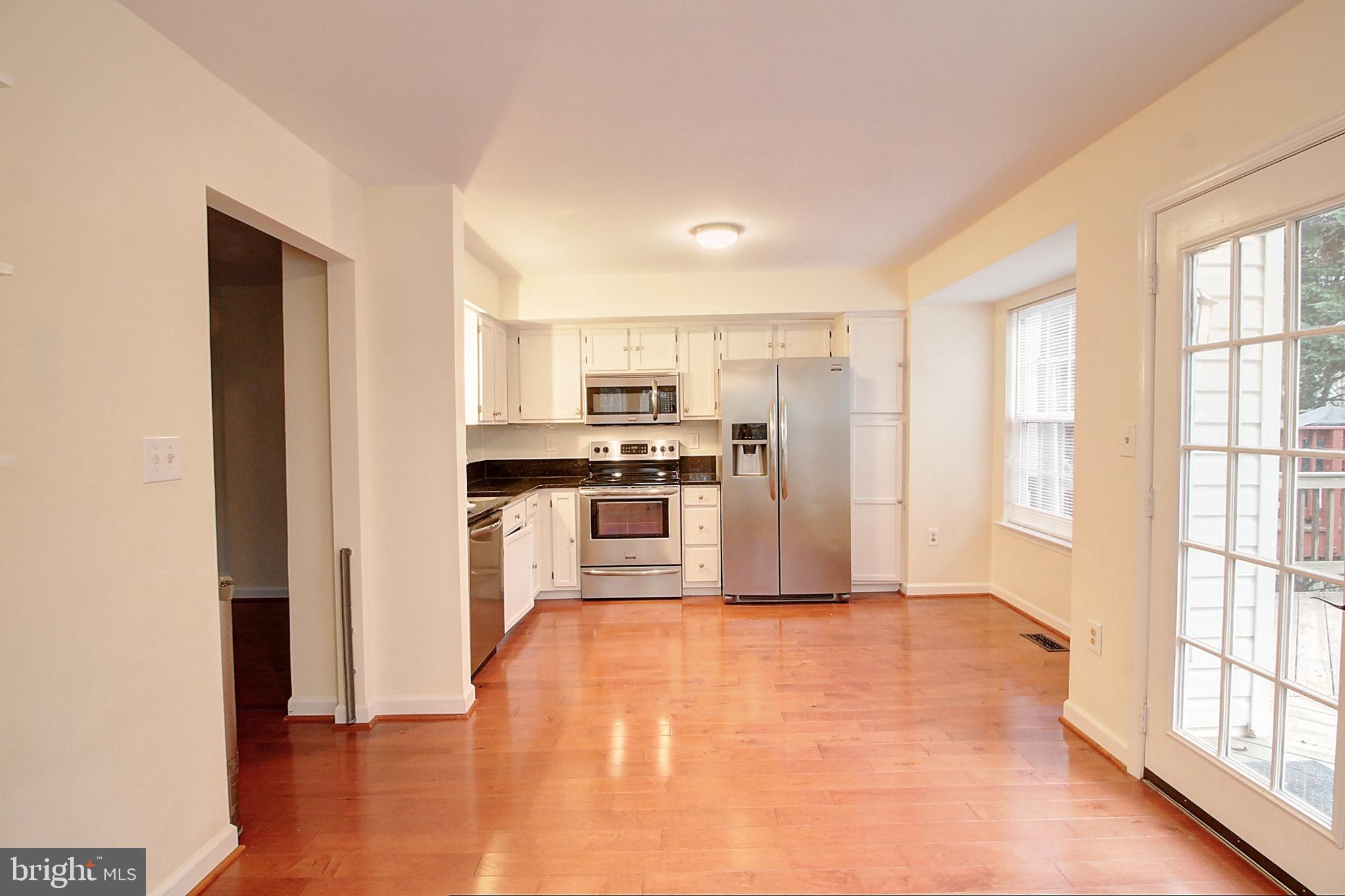 9261 Ridgefield Circle Frederick, MD 21701 - Photo 8 of 27 a kitchen with stainless steel appliances a refrigerator and wooden floor