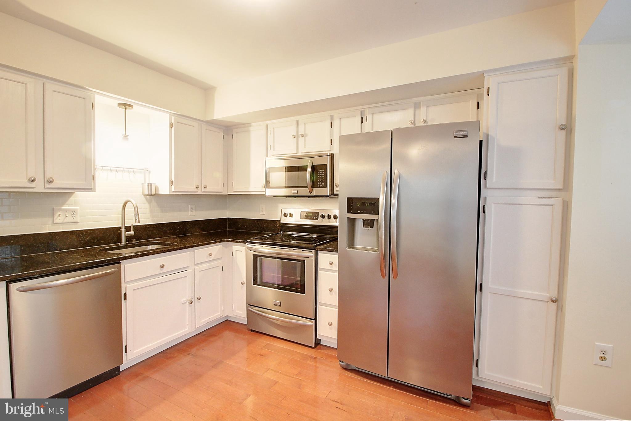 9261 Ridgefield Circle Frederick, MD 21701 - Photo 9 of 27 a kitchen with a refrigerator sink and microwave