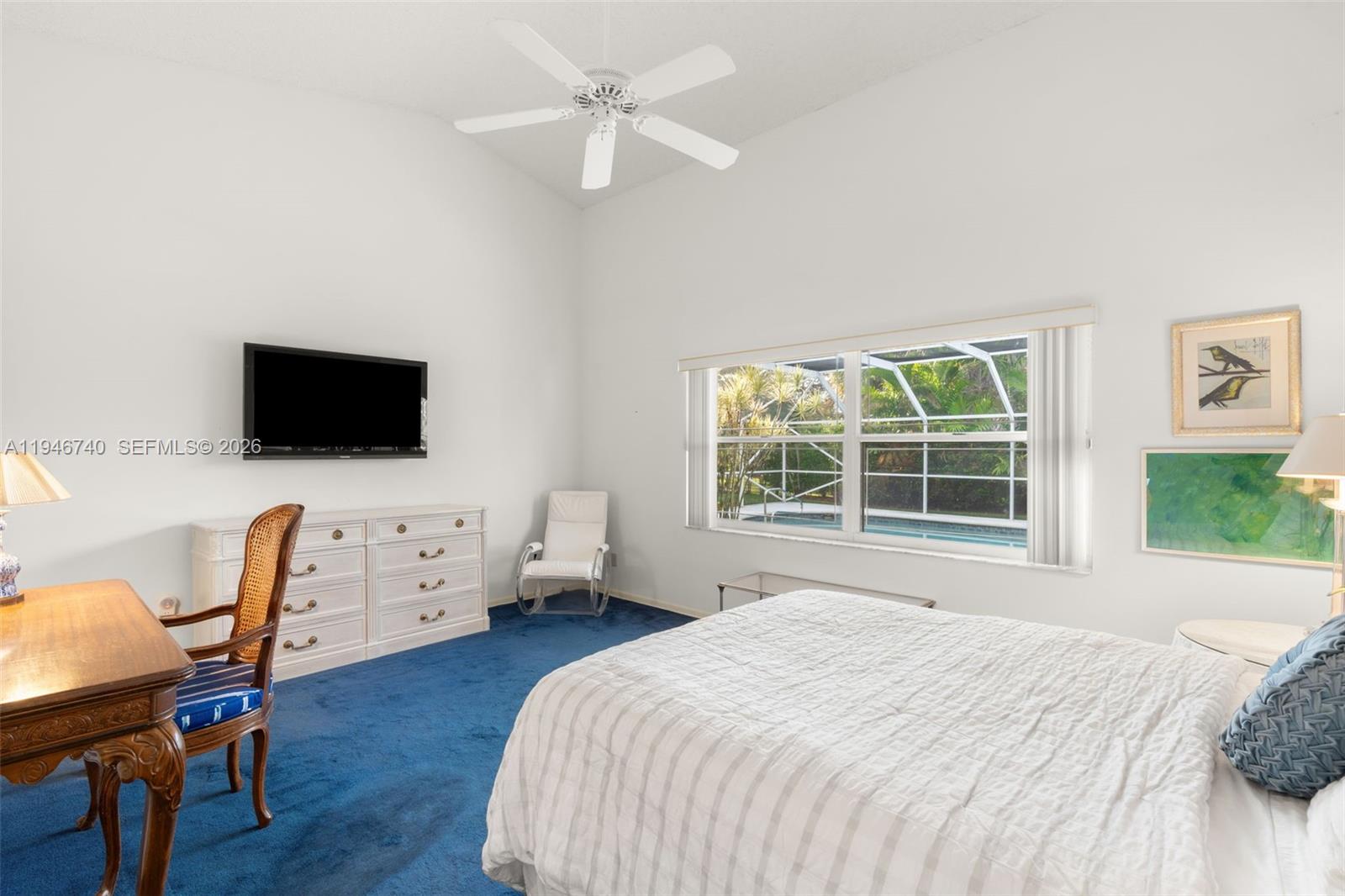 7901 Northwest 86th Terrace Tamarac, FL 33321 - Photo 20 of 42 a bedroom with a bed and a flat screen tv on dresser