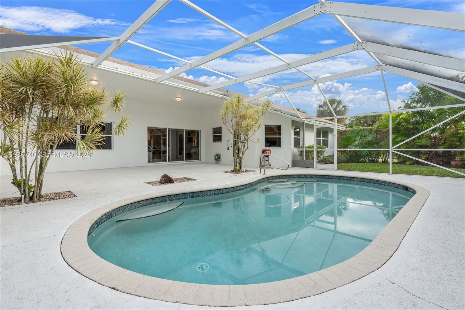 7901 Northwest 86th Terrace Tamarac, FL 33321 - Photo 2 of 42 a view of a swimming pool with a patio