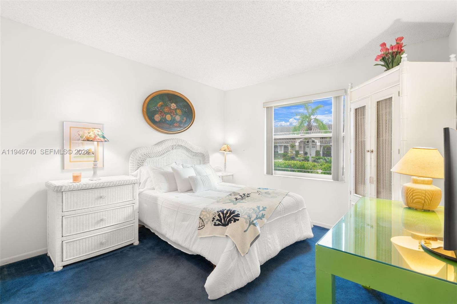 7901 Northwest 86th Terrace Tamarac, FL 33321 - Photo 25 of 42 a bed sitting in a bedroom next to a window