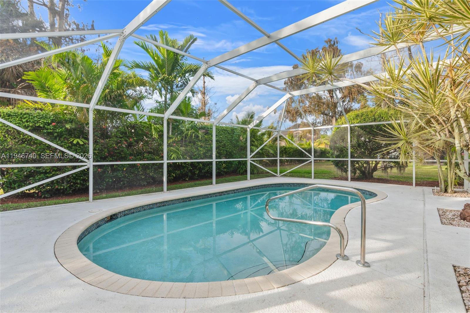 7901 Northwest 86th Terrace Tamarac, FL 33321 - Photo 33 of 42 a view of a swimming pool with a yard and wooden fence