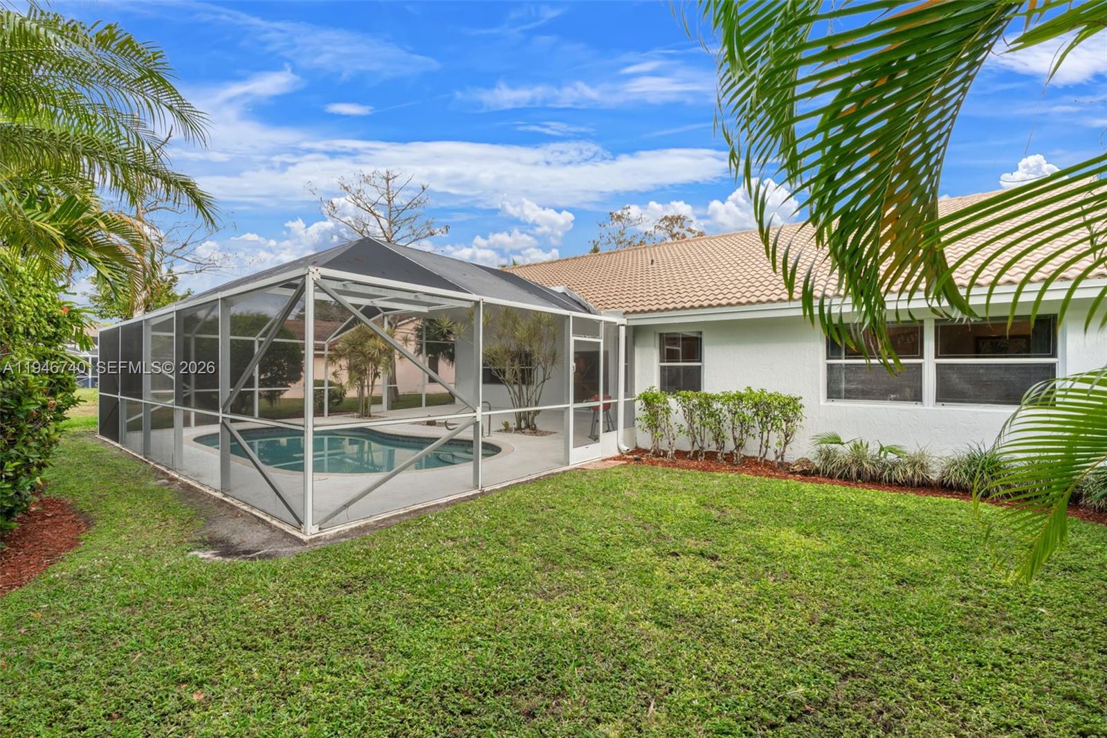 7901 Northwest 86th Terrace Tamarac, FL 33321 - Photo 34 of 42 a view of a house with a yard and sitting area
