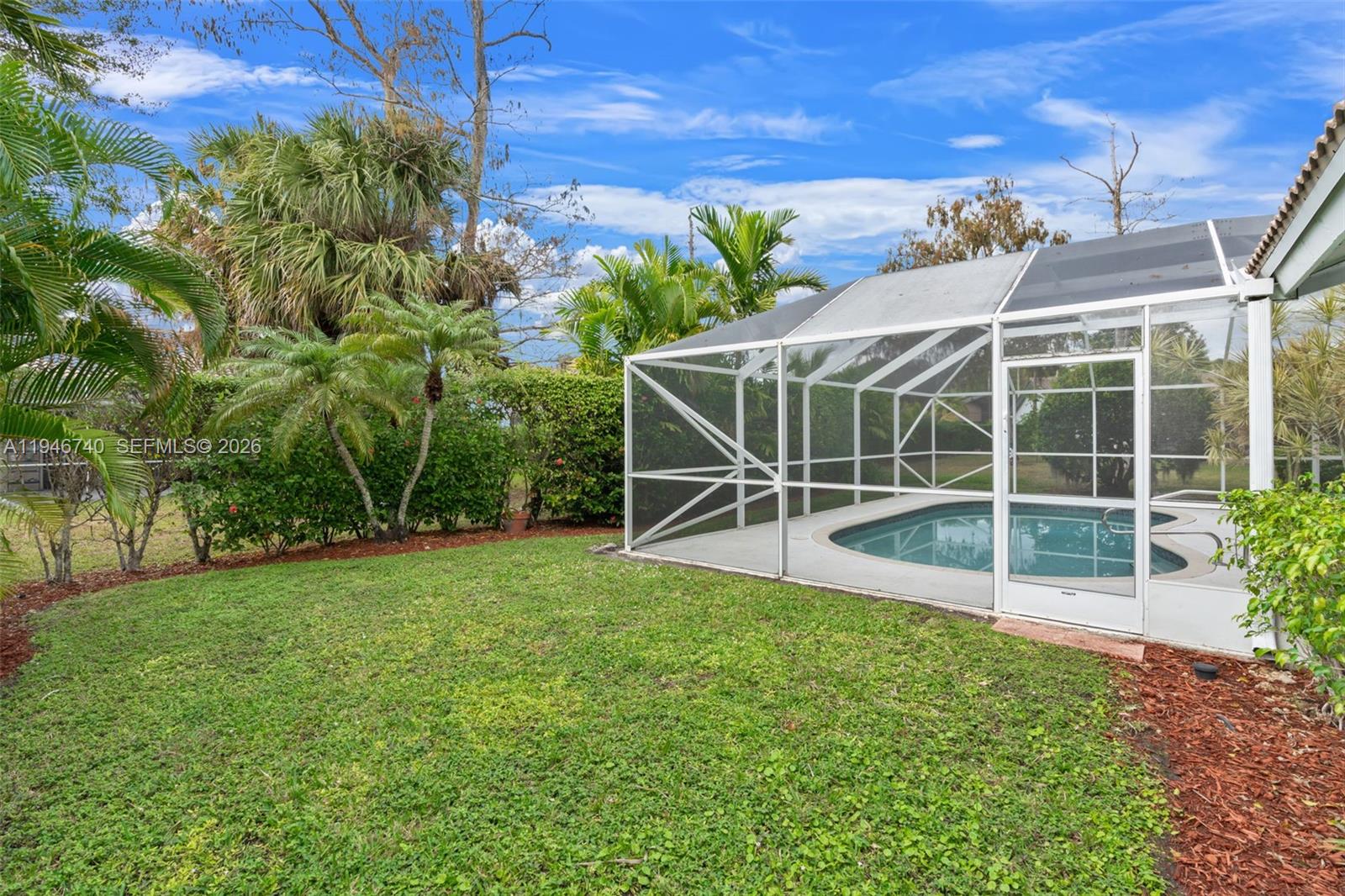7901 Northwest 86th Terrace Tamarac, FL 33321 - Photo 35 of 42 a view of a backyard with table and chairs and potted plants