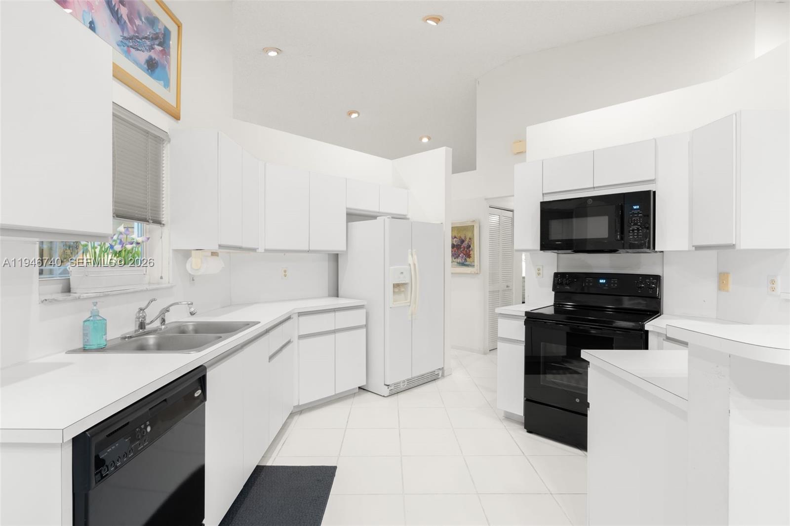 7901 Northwest 86th Terrace Tamarac, FL 33321 - Photo 4 of 42 a kitchen with a sink a stove and cabinets