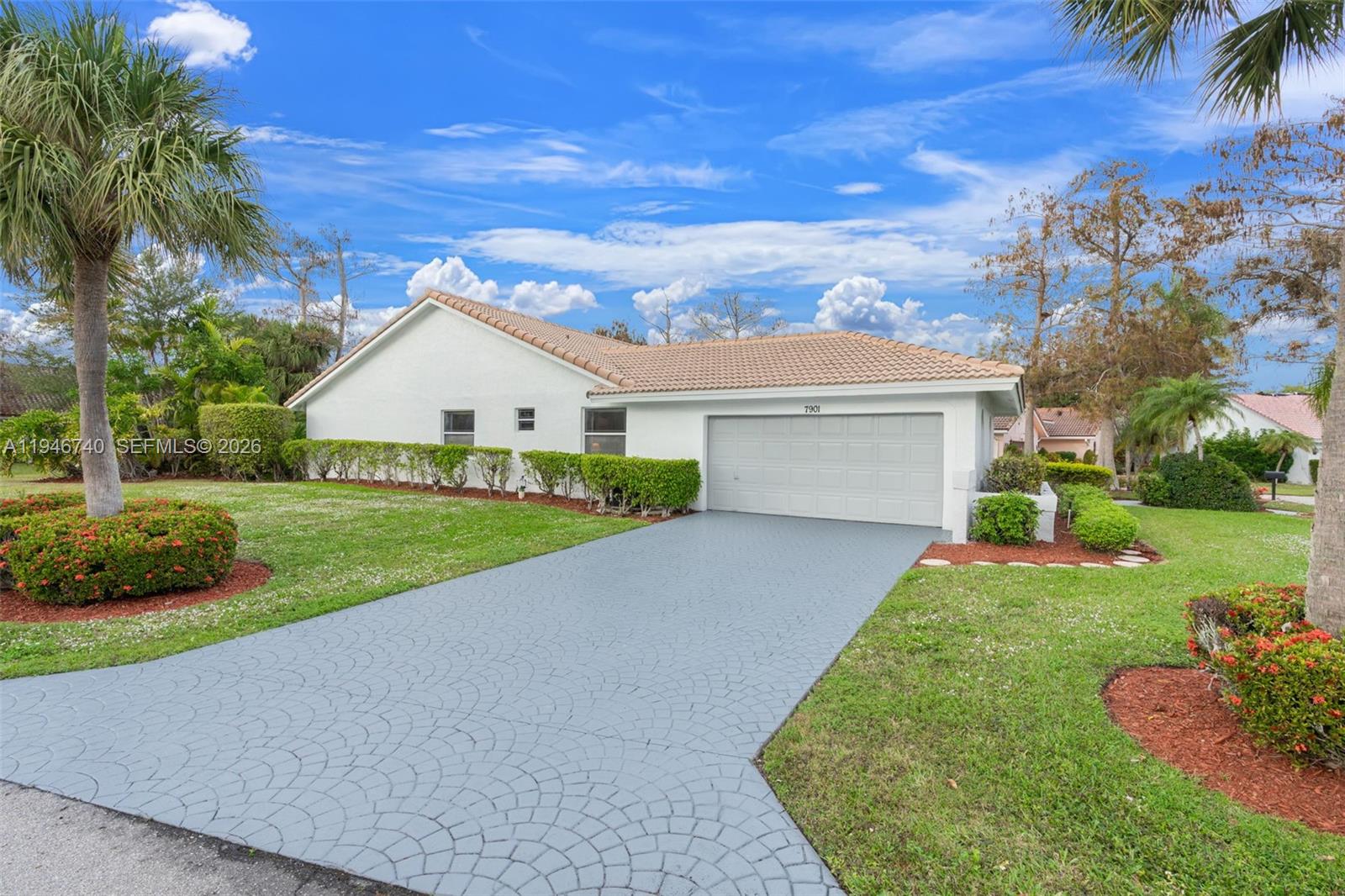 7901 Northwest 86th Terrace Tamarac, FL 33321 - Photo 6 of 42 a view of a house with a yard and potted plants