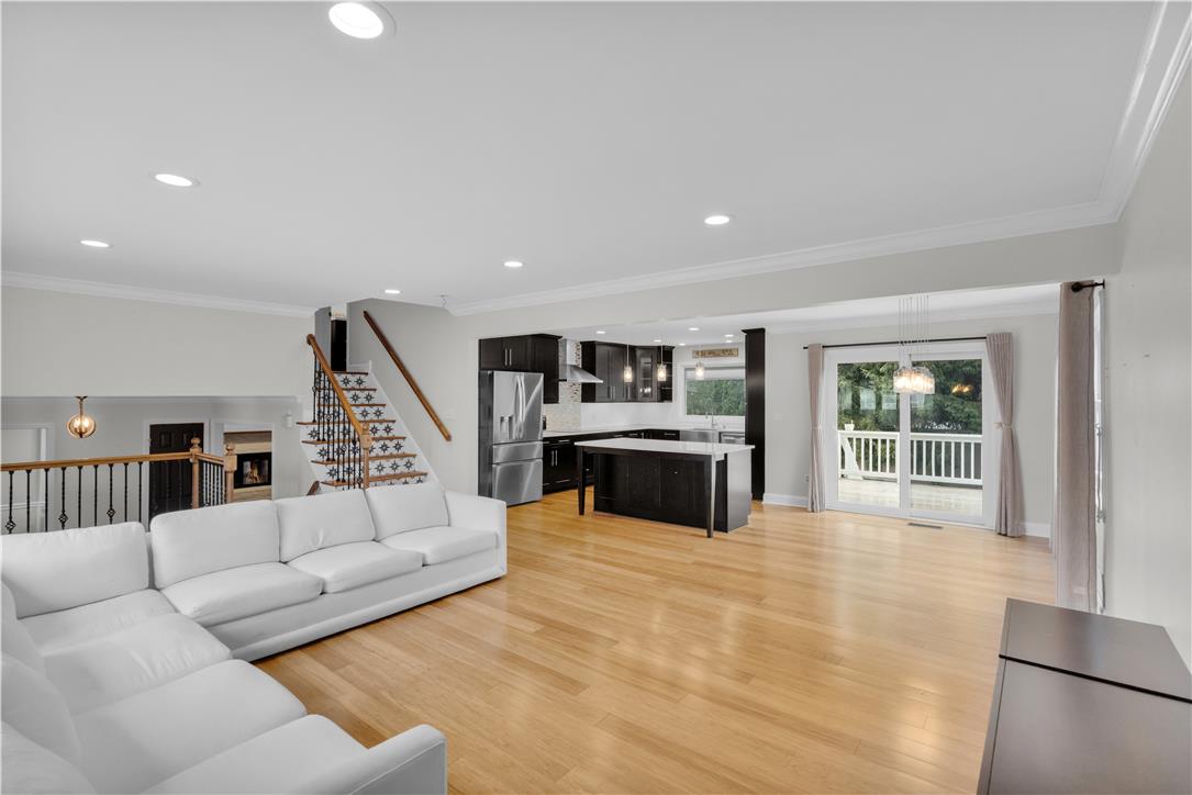 3396 Darien Road Bethlehem, PA 18020 - Photo 20 of 44 Blonde hardwood floors extend across this expansive open-concept living space, uniting the modern kitchen and a welcoming living area.