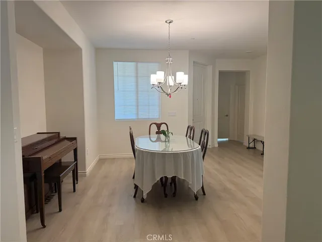 a view of a dining room with furniture and a chandelier