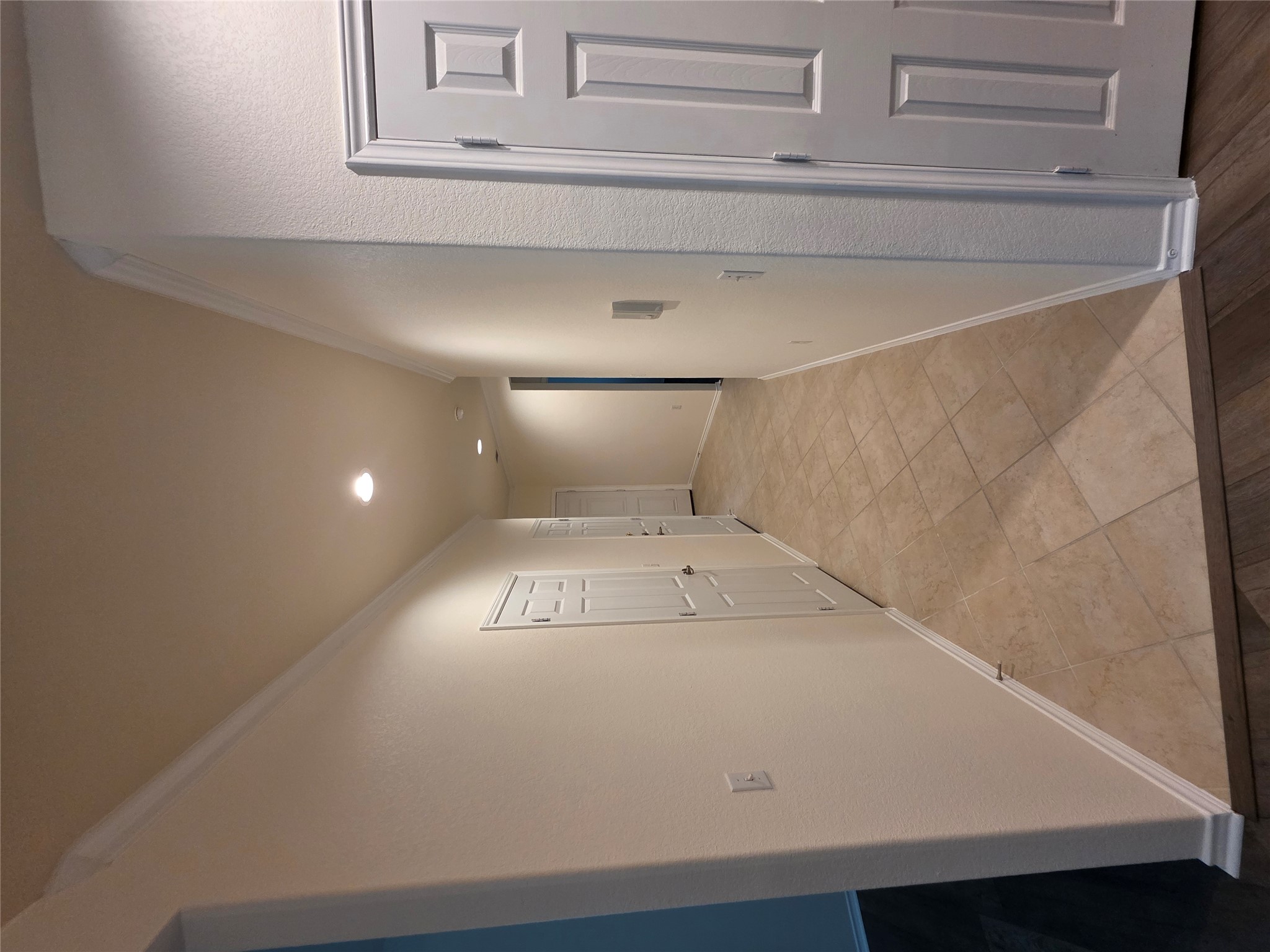 201 Yosemite Road Georgetown, TX 78633 - Photo 9 of 21 Hallway featuring ornamental molding, recessed lighting, light wood-style flooring, and a textured wall