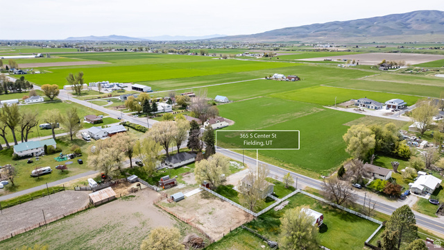 365 South Center Street Fielding, UT 84311 - Photo 35 of 41 Aerial view of property and surrounding area featuring a mountainous background and nearby suburban area