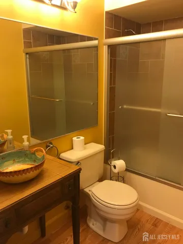 a bathroom with a sink a toilet and shower