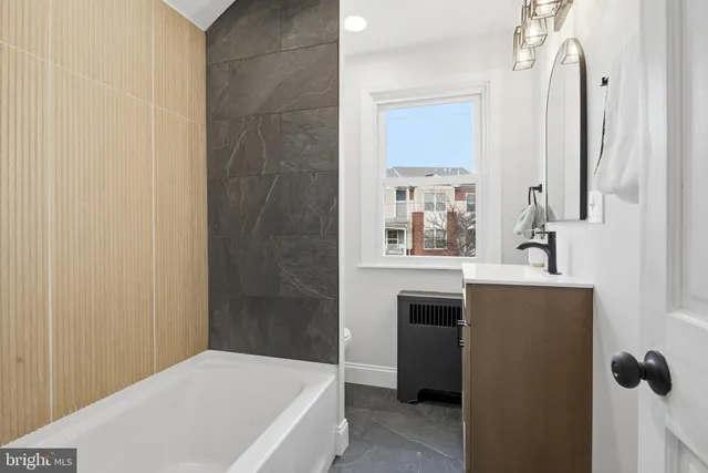 a bathroom with a sink a vanity and a mirror