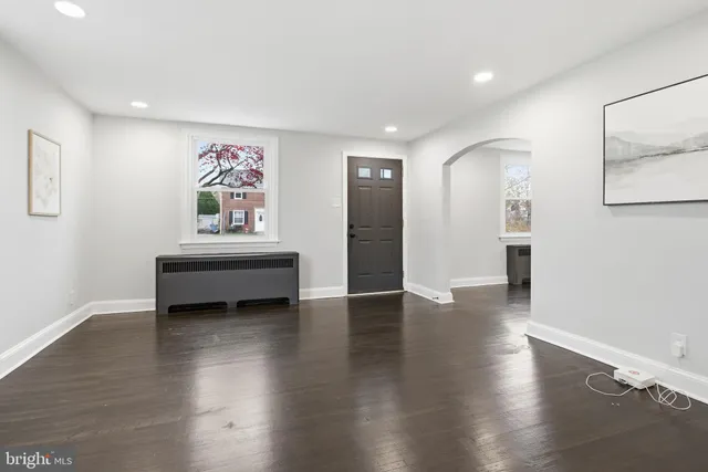 a view of a livingroom with wooden floor and furniture