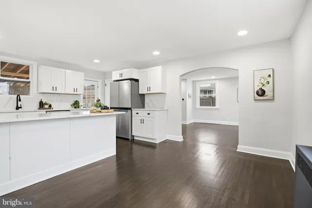 a view of kitchen with wooden floor and electronic appliances
