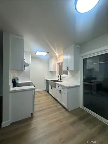 a view of an empty room and wooden floor