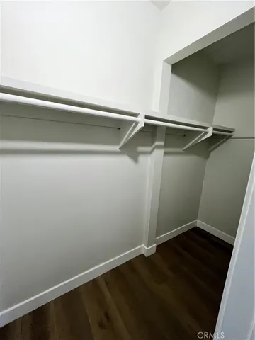 an empty room with wooden floor and closet