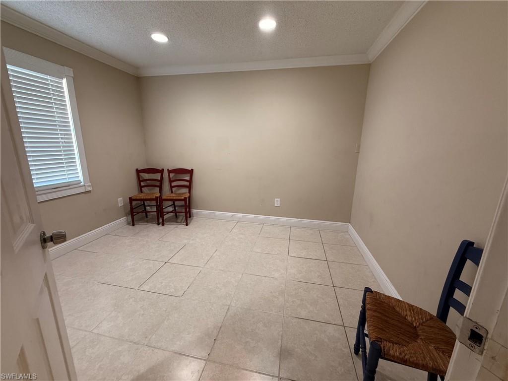 3536 Bolero Way Naples, FL 34105 - Photo 20 of 25 Living area featuring a textured ceiling, recessed lighting, light tile patterned floors, and ornamental molding