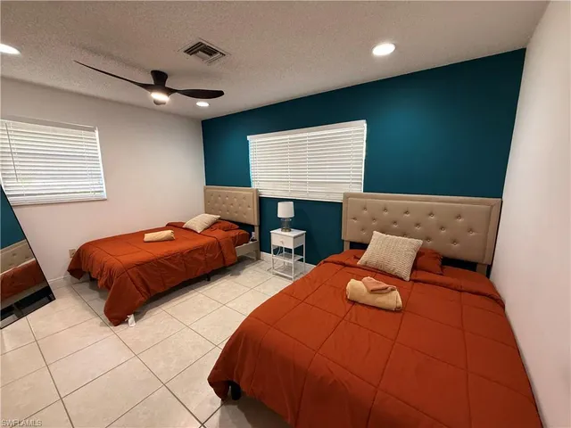 a bedroom with bed and a night stand