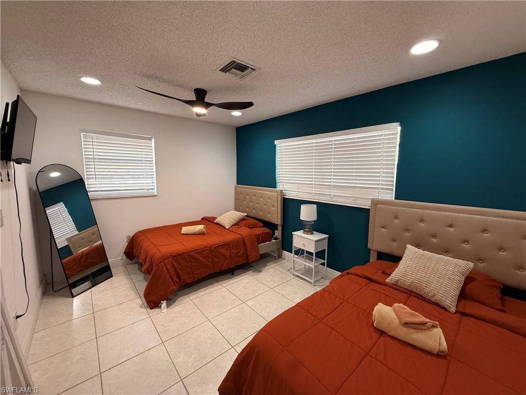 3536 Bolero Way Naples, FL 34105 - Photo 9 of 25 Bedroom featuring recessed lighting, a textured ceiling, light tile patterned flooring, and a ceiling fan