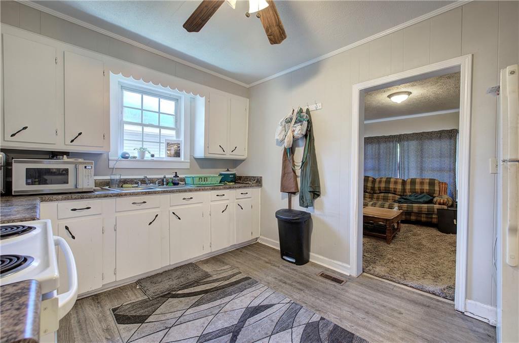 3 Grover Street Southwest Rome, GA 30161 - Photo 11 of 19 a kitchen with granite countertop a stove a sink and a refrigerator