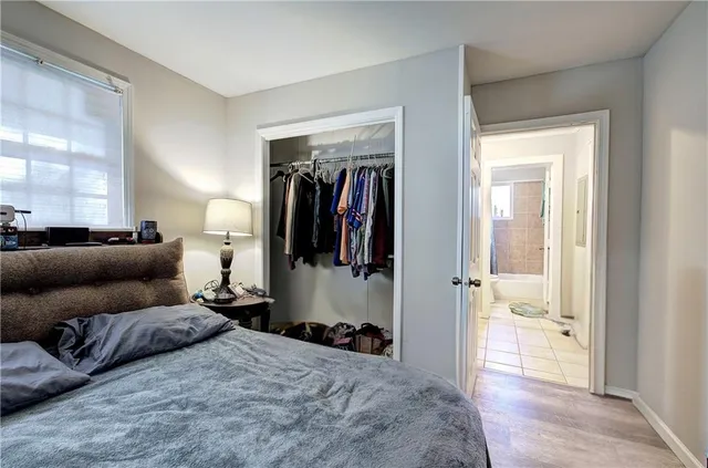a bedroom with a bed and a large mirror