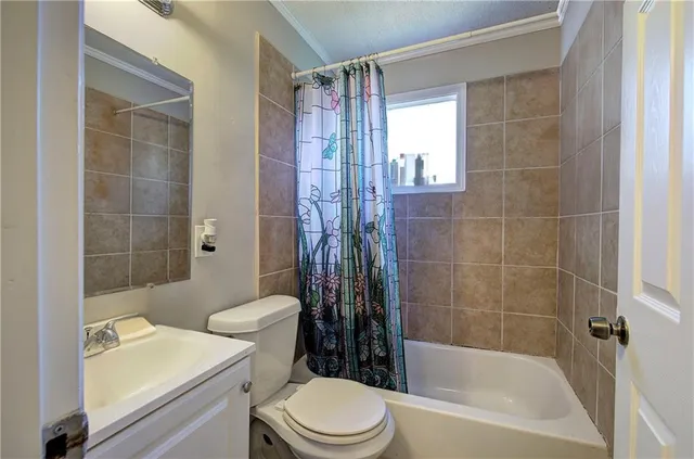 a bathroom with a toilet a sink and shower