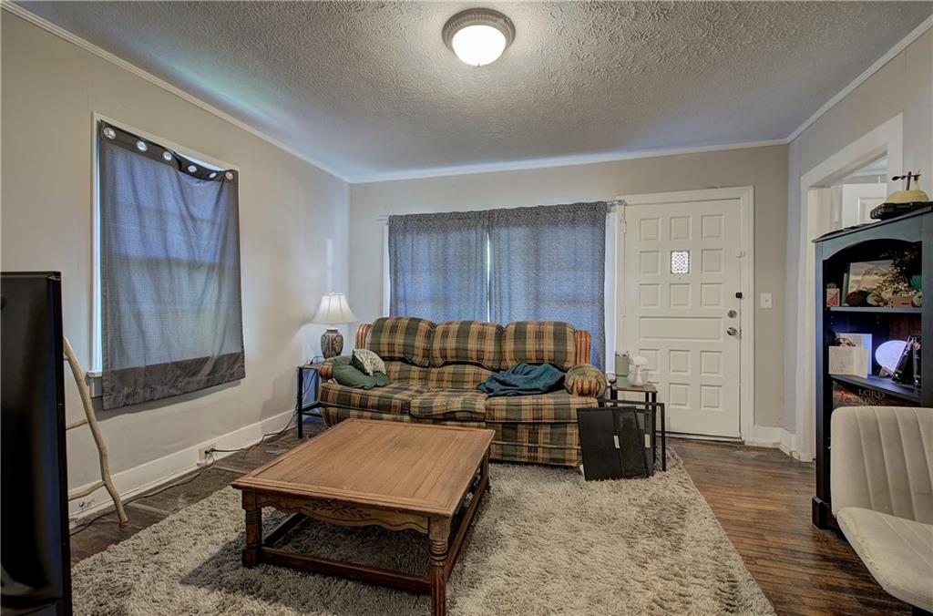 3 Grover Street Southwest Rome, GA 30161 - Photo 17 of 19 a living room with furniture and a book shelf
