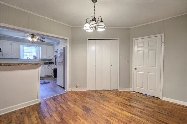 a view of a kitchen with wooden floor and a window