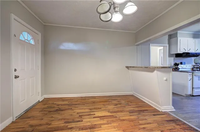 a view of a kitchen with a microwave and cabinets