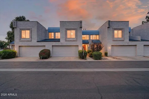 a front view of a house with a yard and a garage