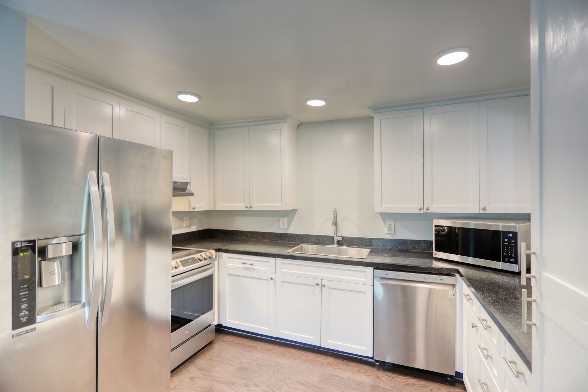 812 Butler Road Portland, TN 37148 - Photo 6 of 13 a kitchen with granite countertop white cabinets and stainless steel appliances